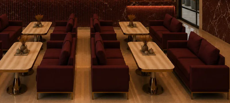 Bordo koltuklar ve ahşap masalarla lounge oturma alanı